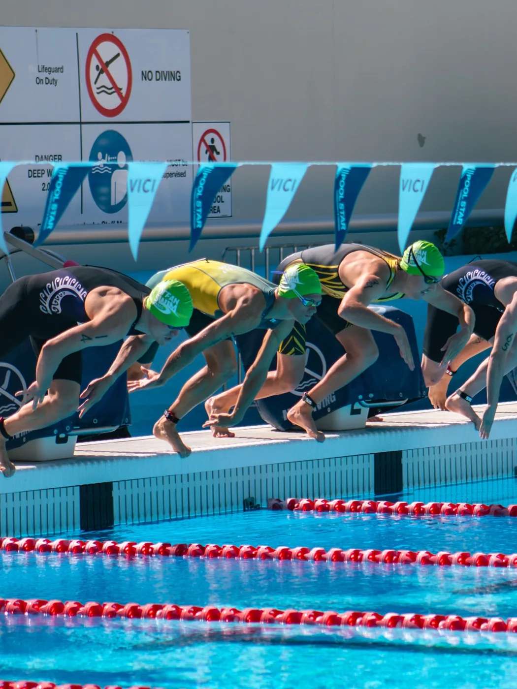 Triathlon swim start — athletes diving