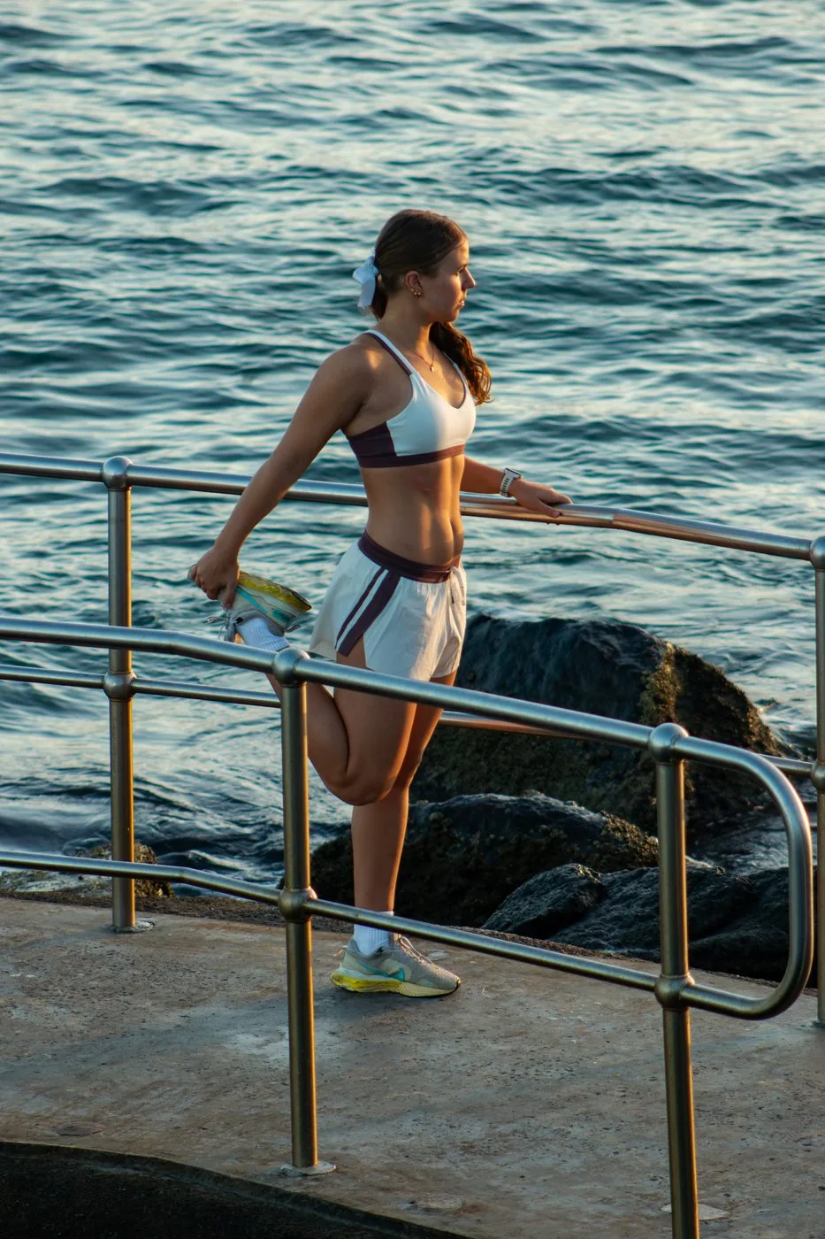 Sports clothing brand — stretching on railing